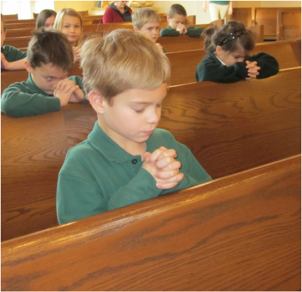 Contact St. Helen Catholic School Newbury Ohio - Child With Folded Hands and Eyes Closed Sitting on Wooden Pew